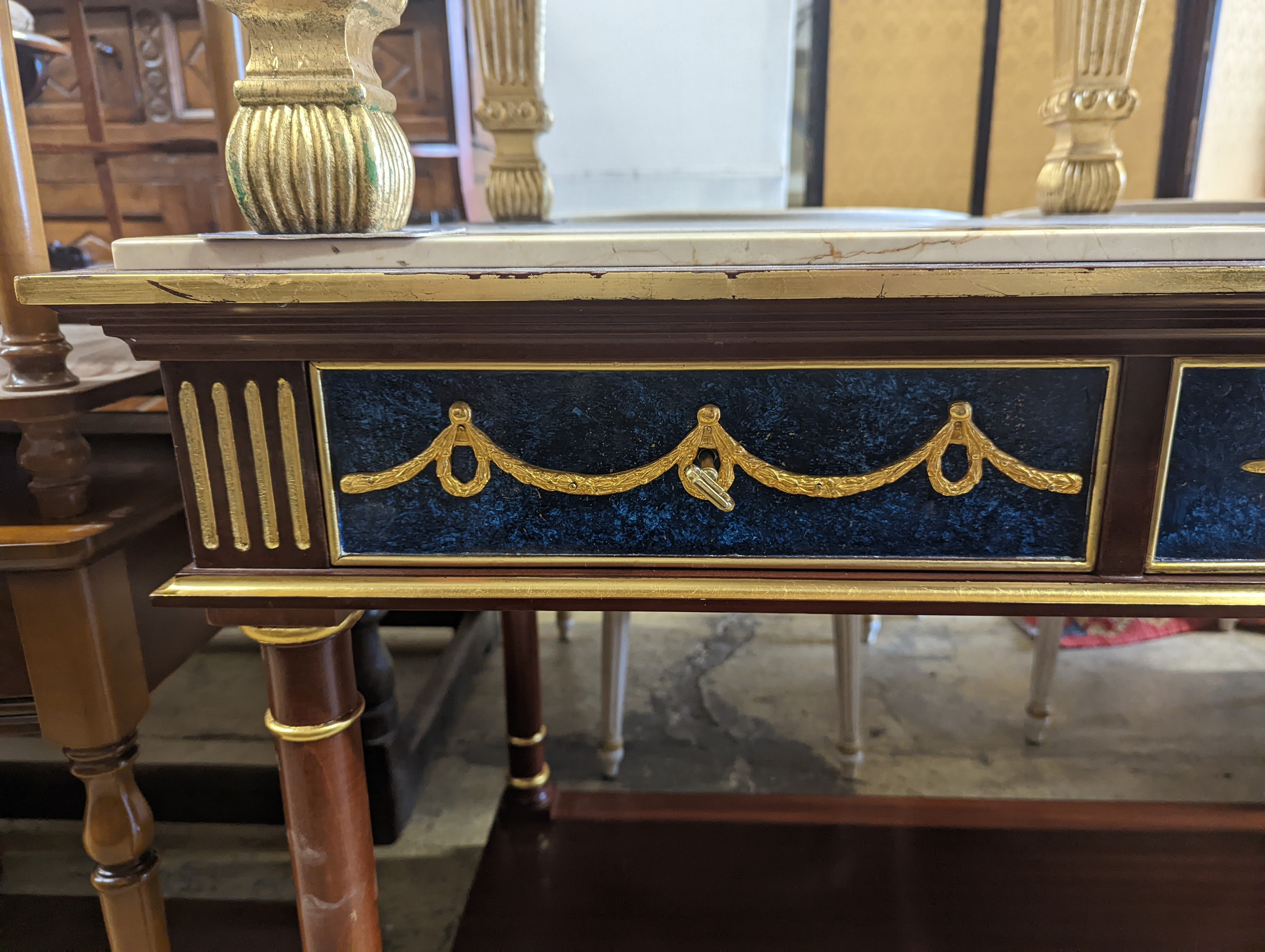 An Empire style parcel gilt and faux malachite marble top console table with concave undertier, width 154cm, depth 65cm, height 80cm